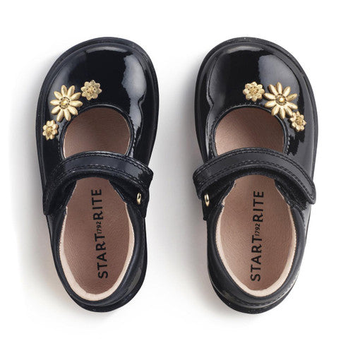 A girls Mary Jane shoe by Start Rite, style Fairy Tale, in black patent with gold flower detail and velcro fastening. Top view of pair.