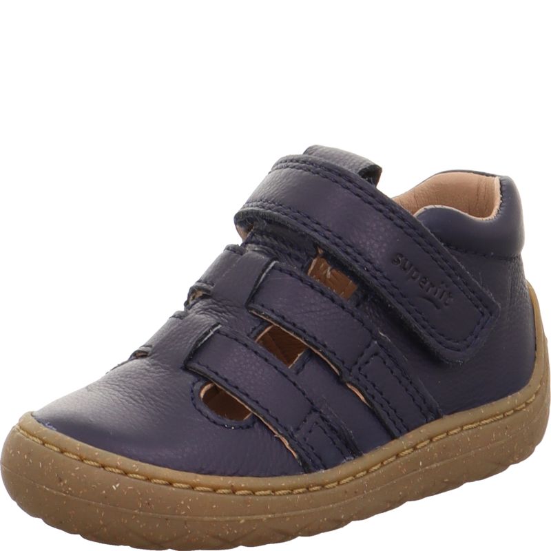 A boys first shoe by Superfit, style Saturnus, in Navy leather with cut out detail, toe bumper and velcro fastening. Angled left side view.