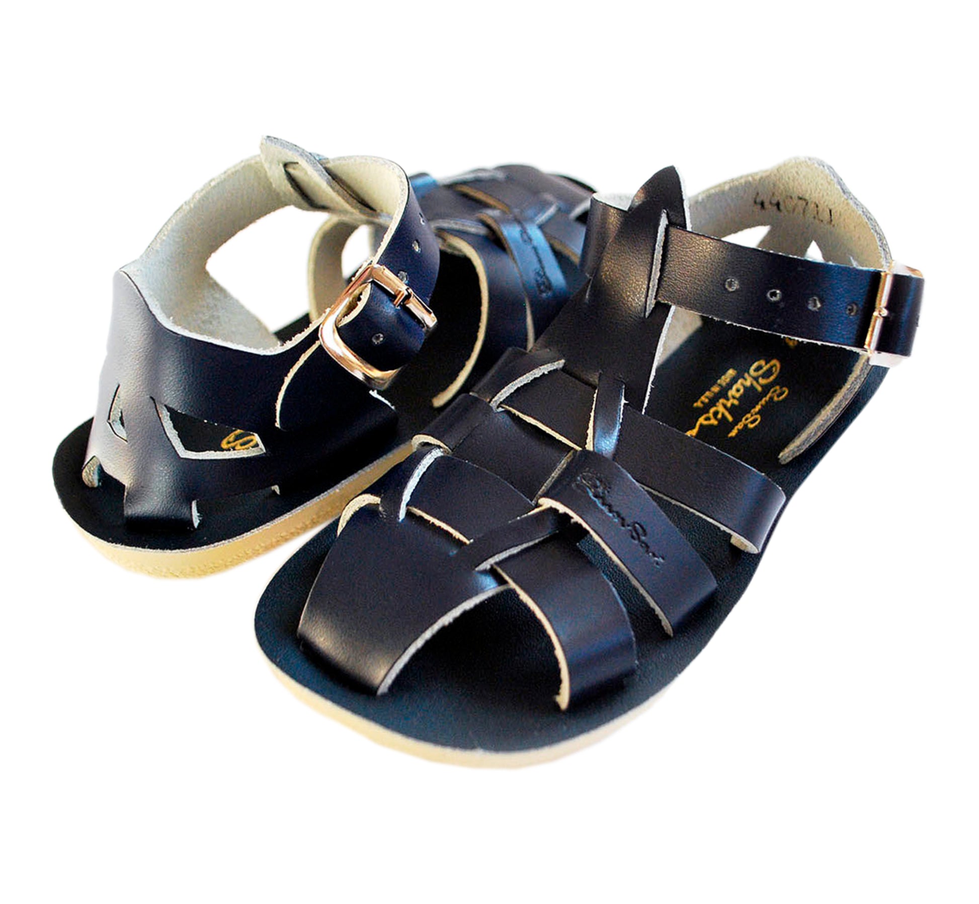 A unisex shark style sandal by Salt Water Sandals in navy with  buckle fastening around the ankle. Closed Toe and caged back with woven detail across the instep. Top view.