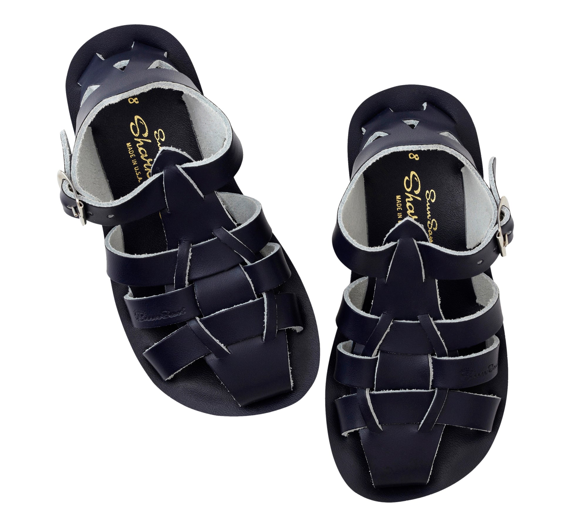 A unisex shark style sandal by Salt Water Sandals in navy with  buckle fastening around the ankle. Closed Toe and caged back with woven detail across the instep. Pair view.