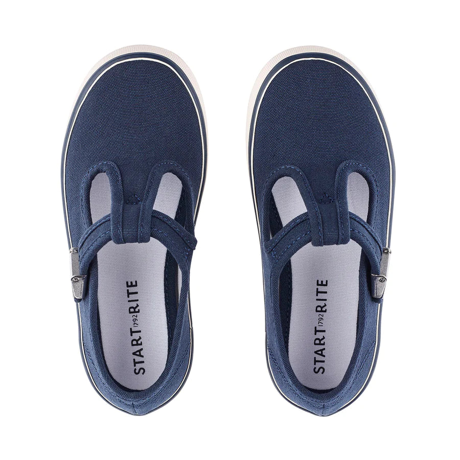 A pair of unisex T-Bar canvas shoes by Start-Rite, style Treasure, in navy with white sole and silver buckle fastening. View from above.