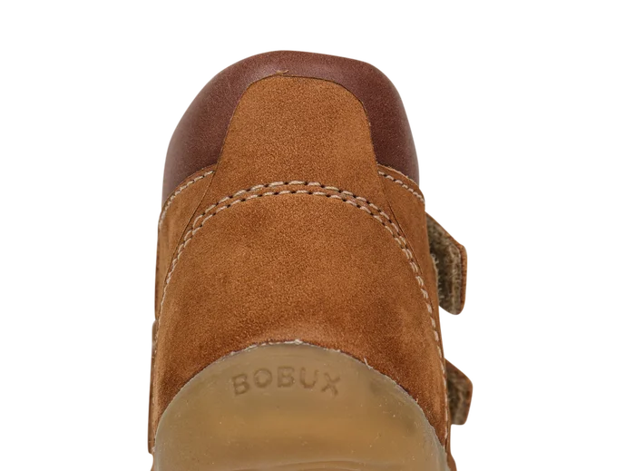 A boys ankle boot by Bobux, style Step Up Timber, in tan nubuck with brown leather trim amd double velcro fastening. Back view.
