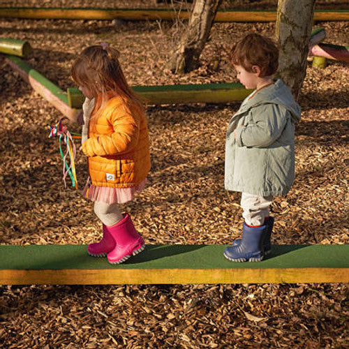 A unisex wellie by Start-Rite, style Baby Mudbuster, in blue and grey with fur lining and drawstring fastening. Lifestyle image.