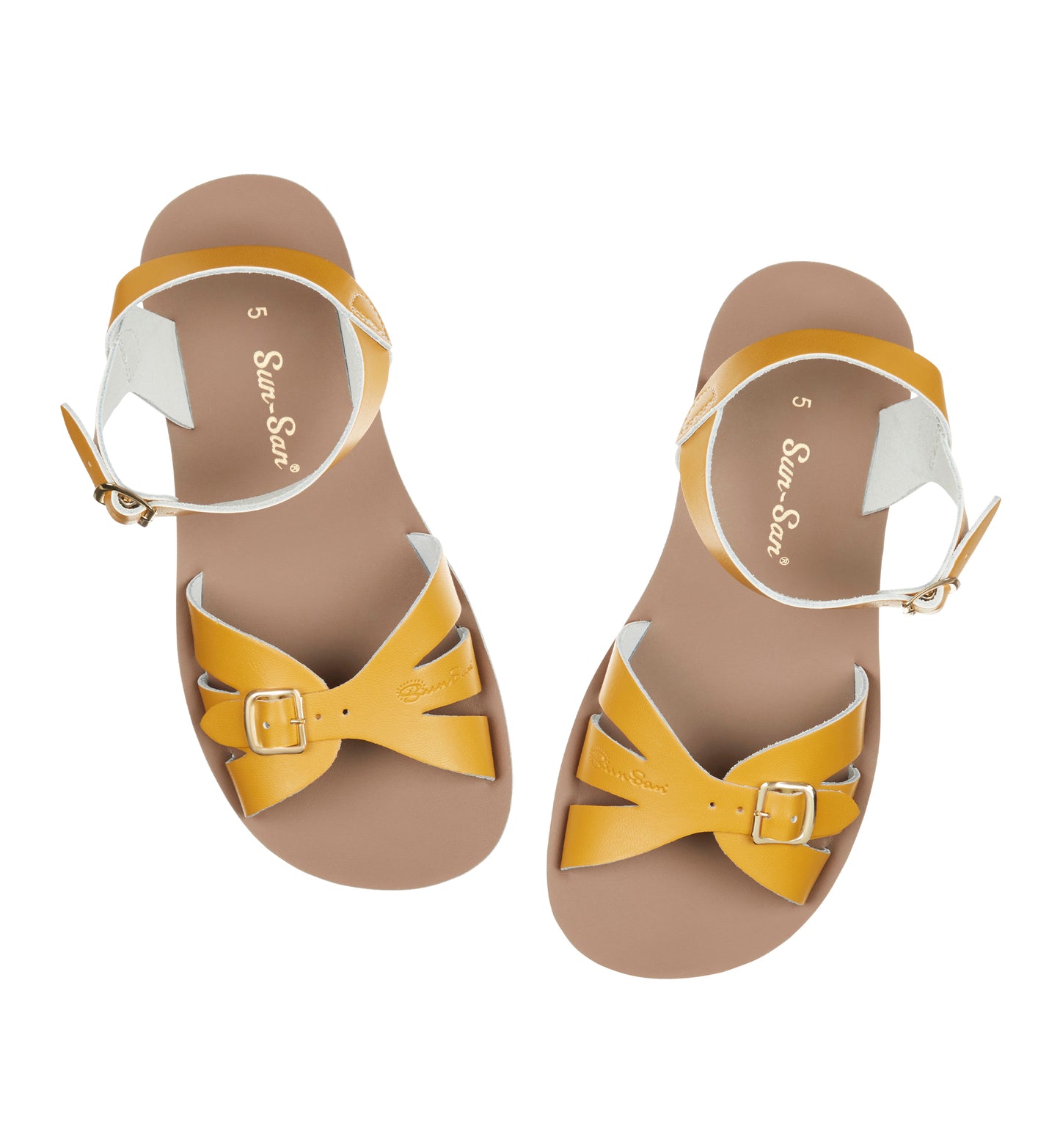 A Boardwalk style girls sandal by Salt Water Sandals in mustard with double buckle fastening across the toes and around the ankle. Open Toe and Sling-back. Pair view.