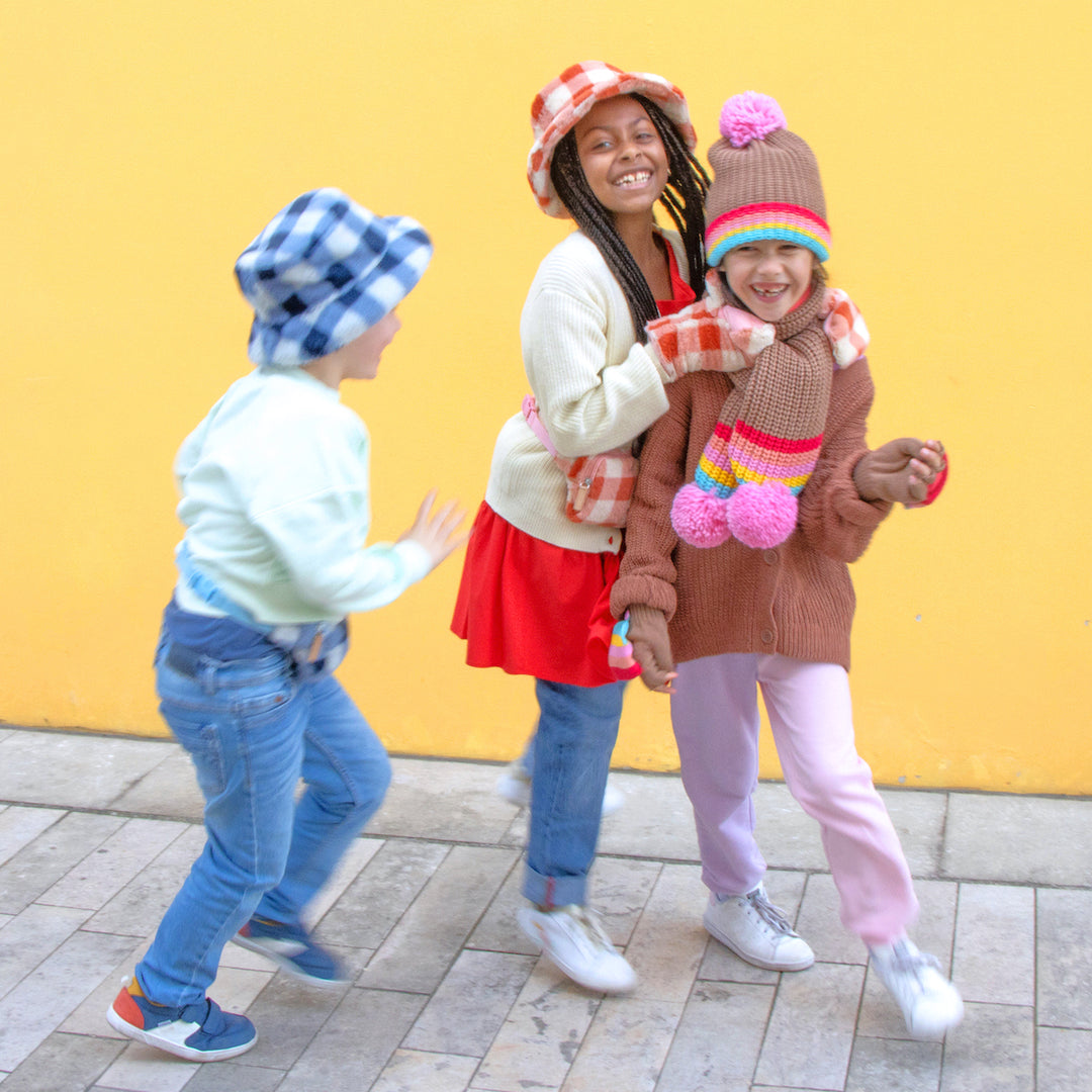 A bucket hat by Rockahula, style Furry Checked, in blue checked fur. Lifestyle image.