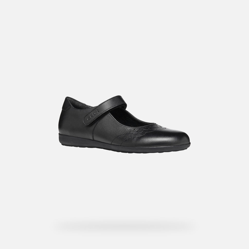 A girls Mary Jane school shoe by Geox, style J46MDI Iberide Girl, in black with punch hole detail and velcro fastening. Angled view.