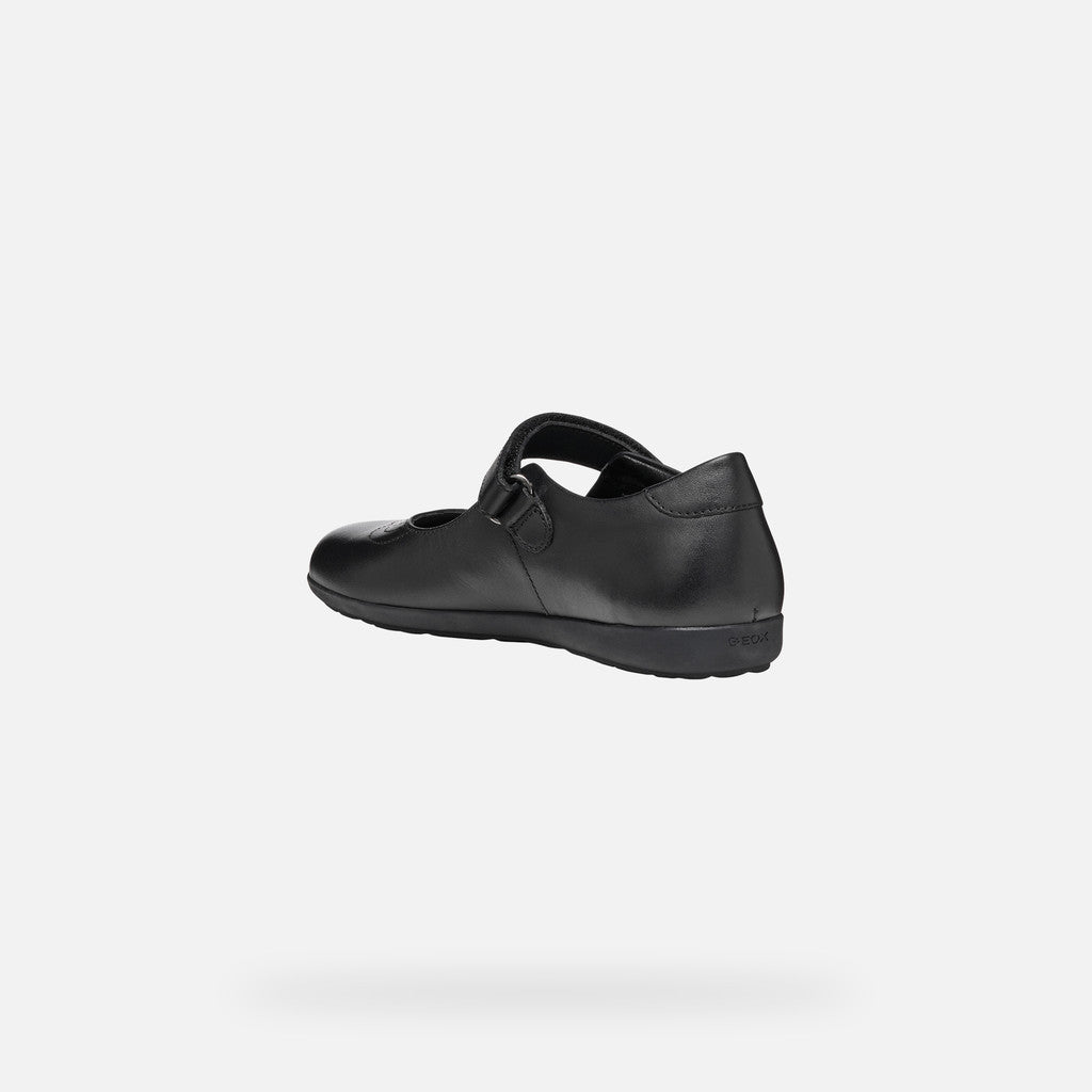 A girls Mary Jane school shoe by Geox, style J46MDI Iberide Girl, in black with punch hole detail and velcro fastening. Angled view of left side.