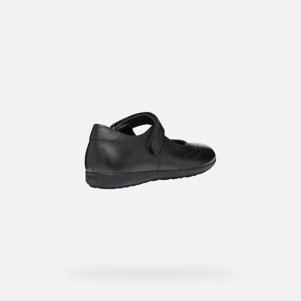 A girls Mary Jane school shoe by Geox, style J46MDI Iberide Girl, in black with punch hole detail and velcro fastening. Angled view of right side.