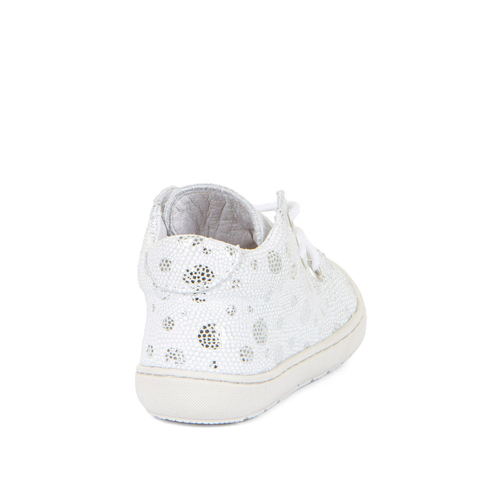 A girls ankle boot by Froddo, style Ollie Laces G2130307-5, in white/silver spot leather  with lace up fastening and toe bumper. Angled back view.