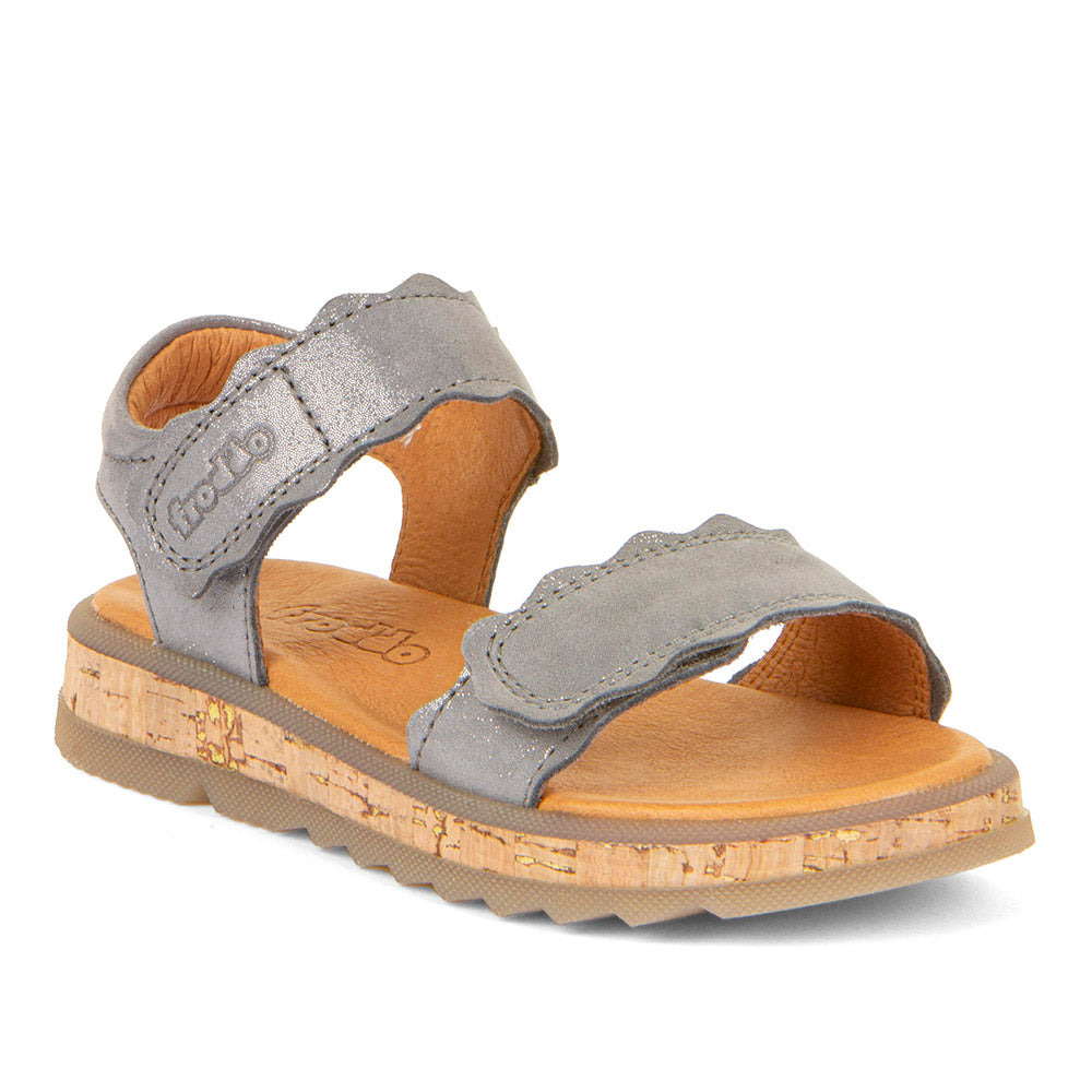 A girls open toe sandal by Froddo, style Alana G3150253-7, in silver leather set on cork effect sole unit with velcro fastening. Angled view.