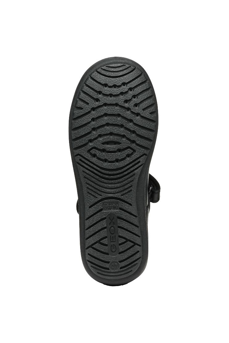 A girls Mary Jane school shoe by Geox, style J467VA Hadriel Girl, in black with punch hole detail, toe bumper and velcro fastening. Sole view.