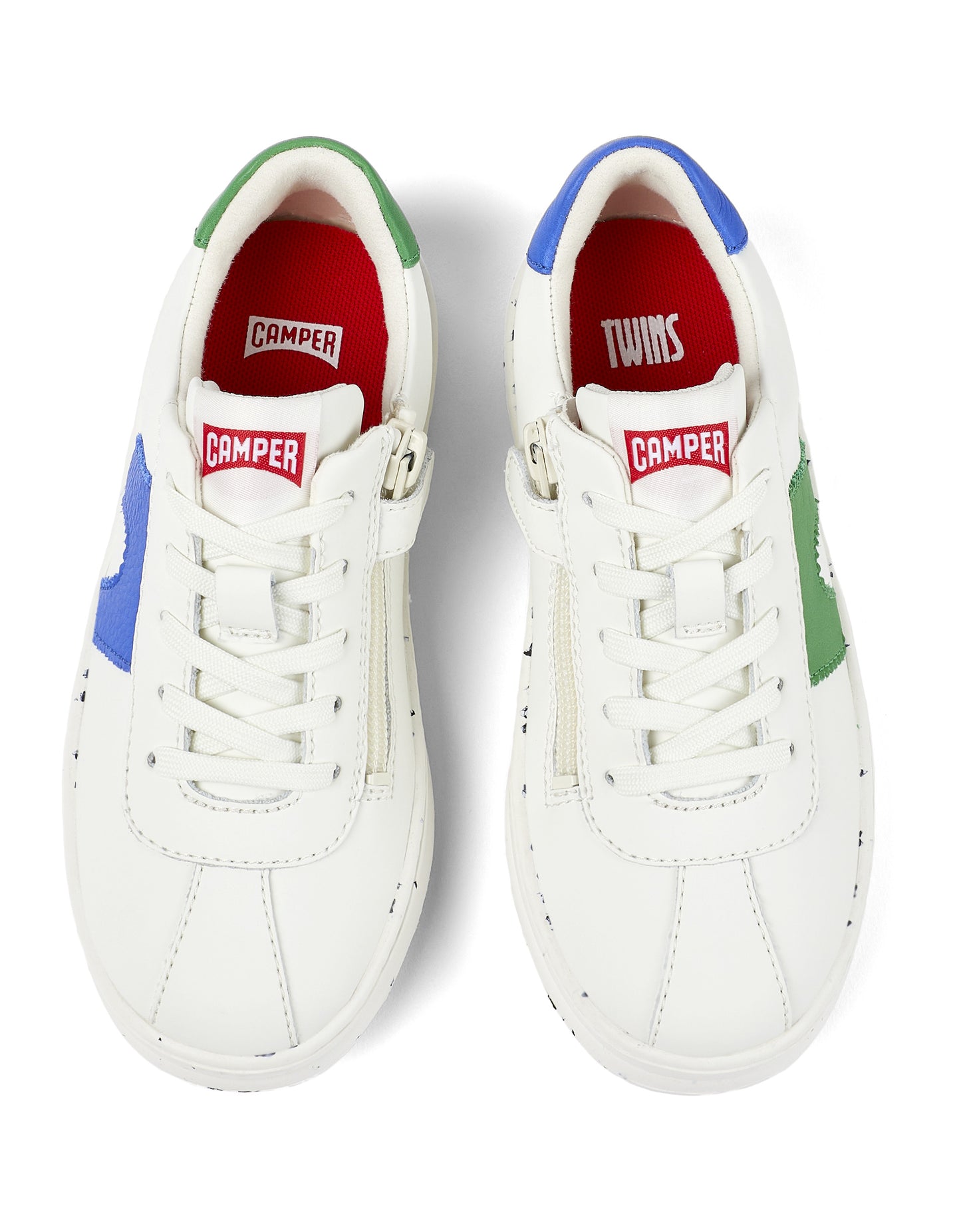 A unisex trainer by Camper, Style Twins Kids, in white with asymmetric blue and green detail. Lace/Zip fastening. Above view of a pair.