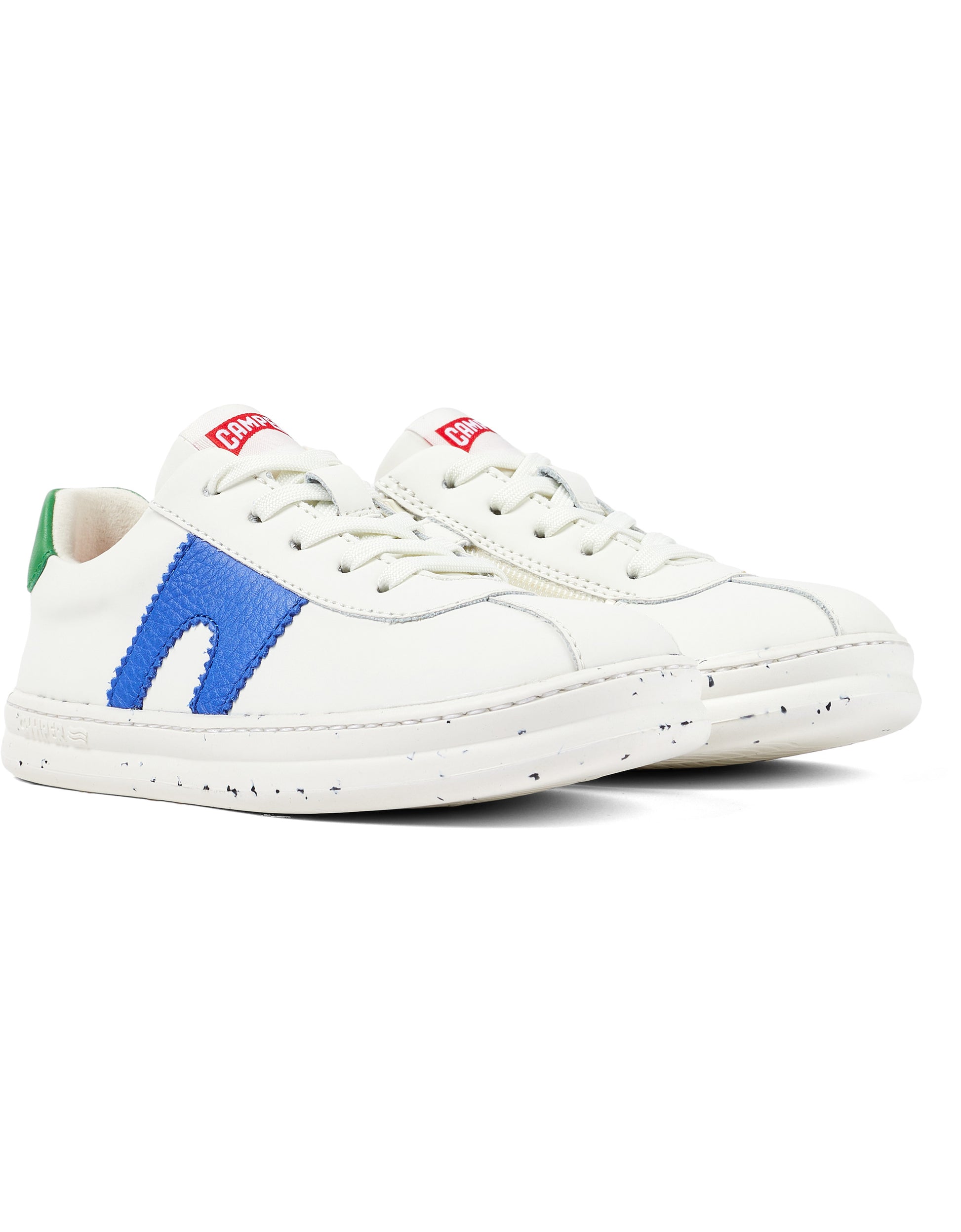 A unisex trainer by Camper, style Twins Kids, in white with asymmetric blue and green detail. Lace/Zip fastening. Front angled view of a pair.