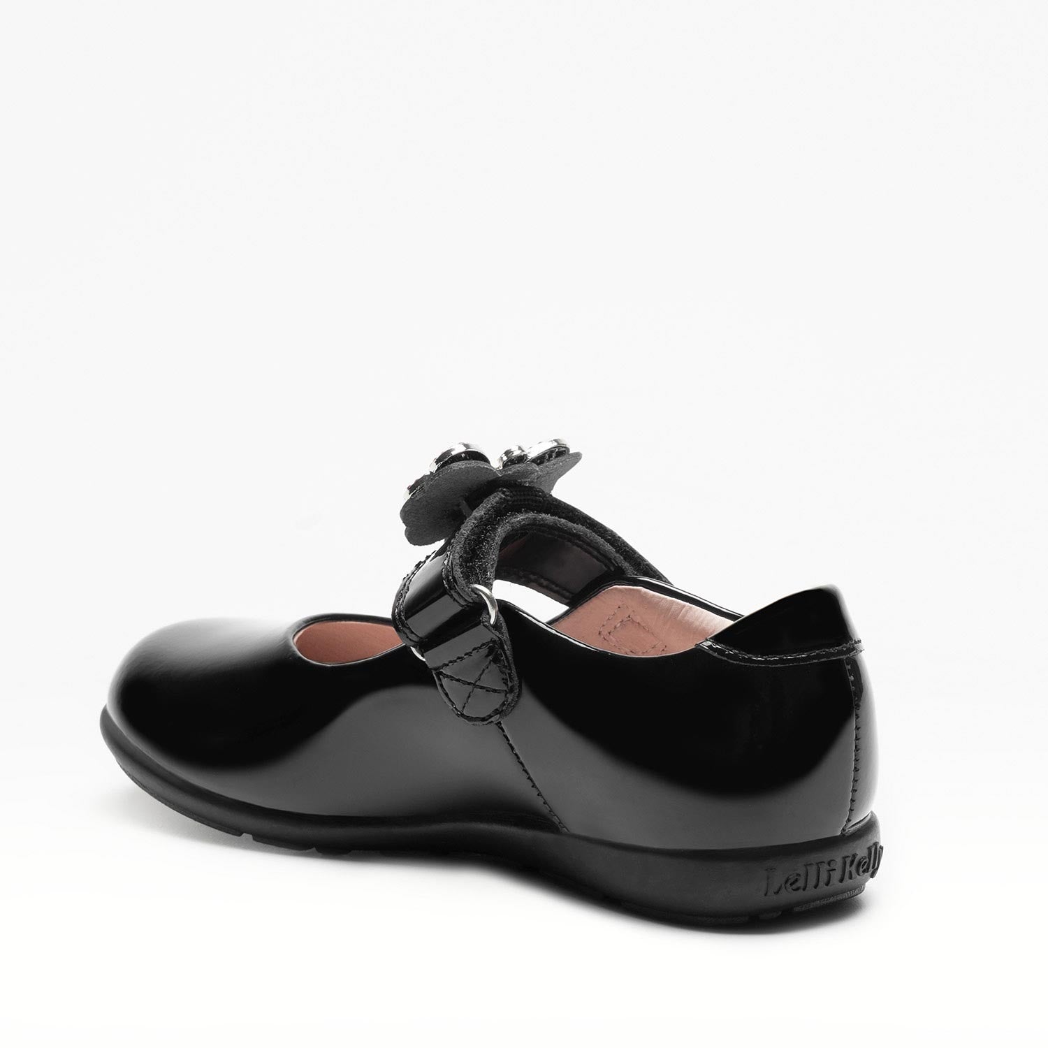 A girls Mary Jane school shoe by Lelli Kelly, style LKSO8641 Luna, in black patent leather with velcro fastening and detachable multicoloured embellished butterfly. Angled left side view.