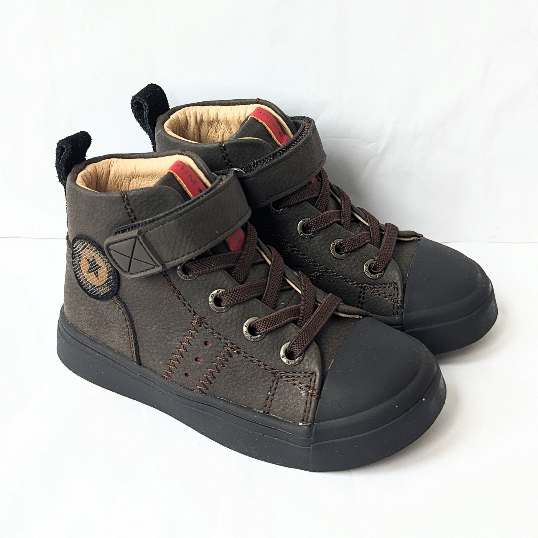 A pair of hi-top unisex boots by Shoesme, style SH23W024-D, with toe bumper and elastic lace and velcro fastening. Angled view.