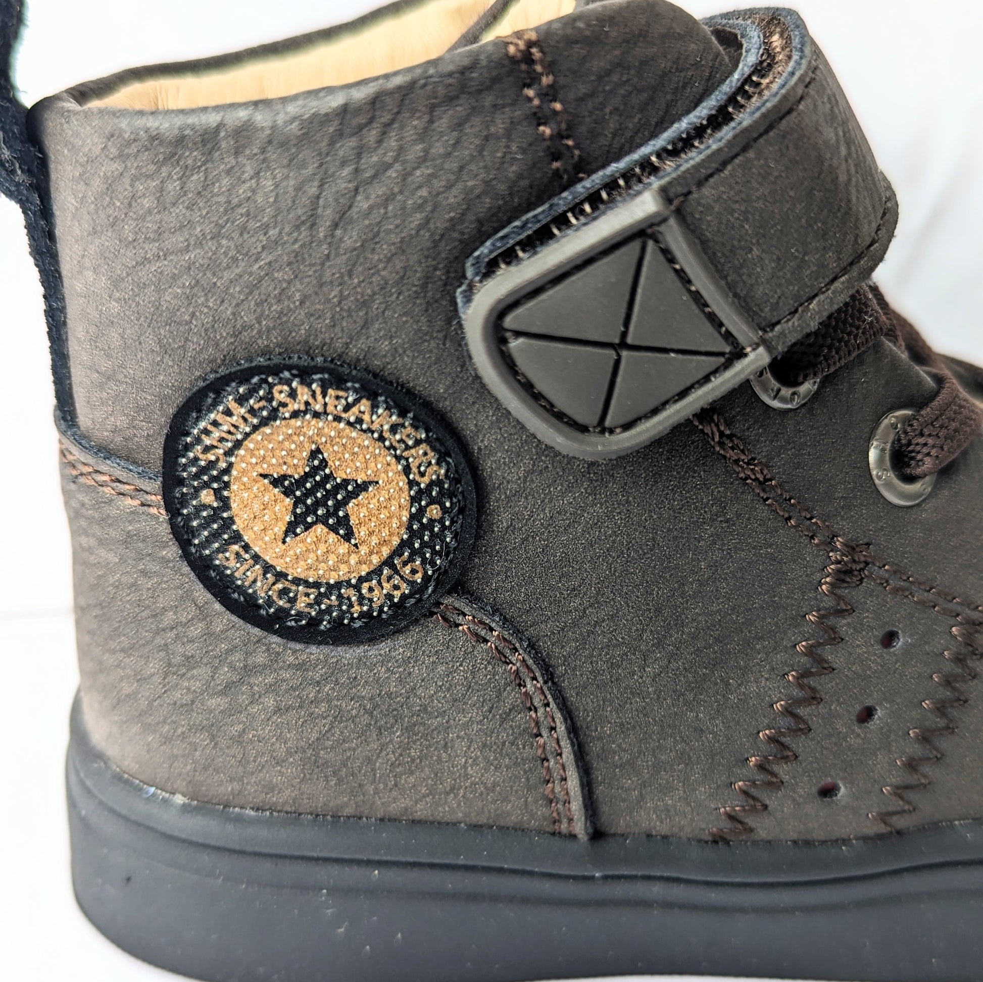 A hi-top unisex boot by Shoesme, style SH23W024-D, with toe bumper and elastic lace and velcro fastening. Close up of star motif.