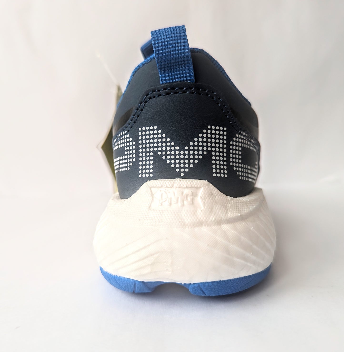 A boys trainer by Primigi, style B&G Rapid 4962511, in navy and blue with elastic lace and velcro fastening. View from back.