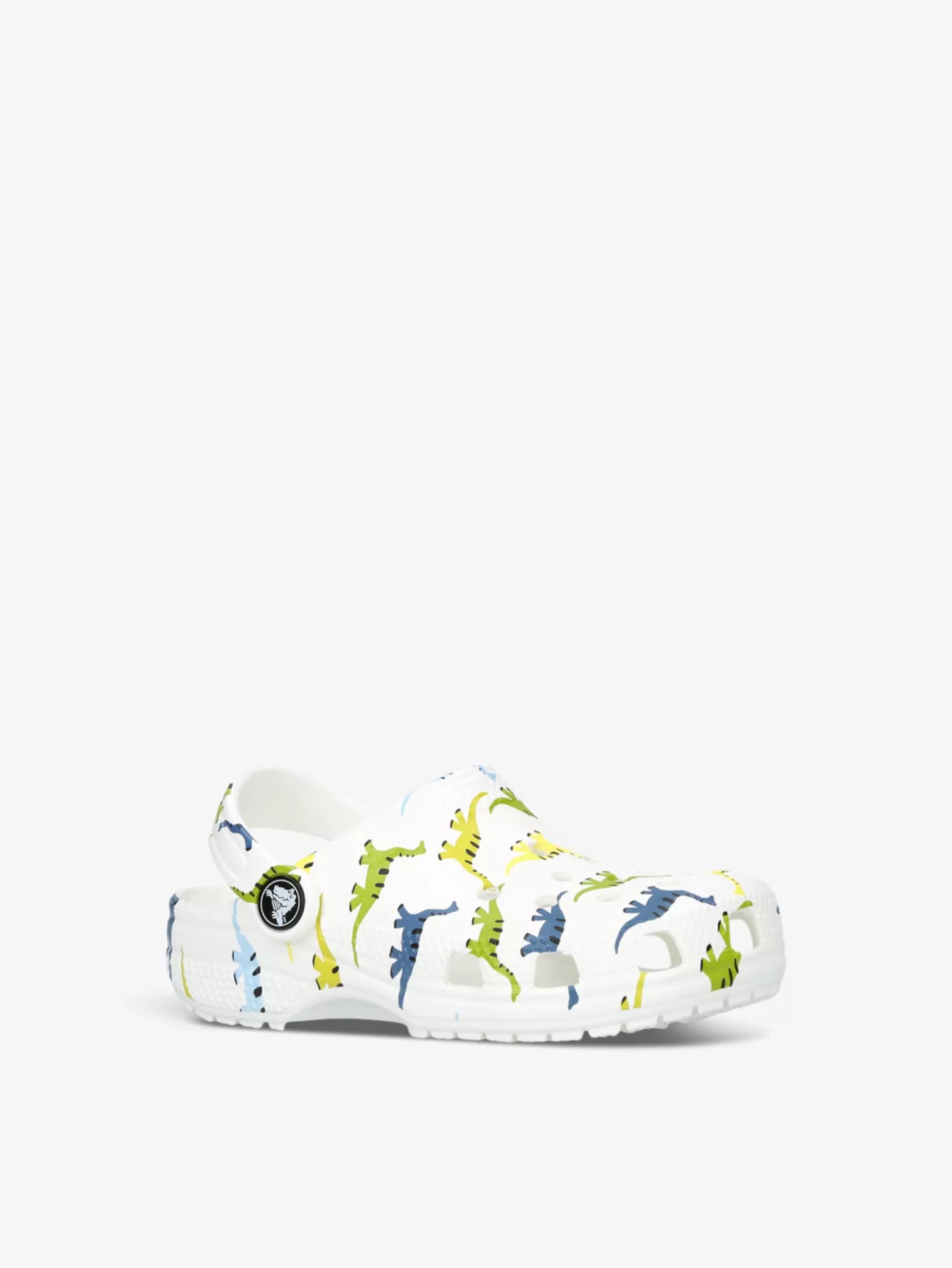 A classic clog by Crocs, style Tod in white with dinosaur print. Right angled view.