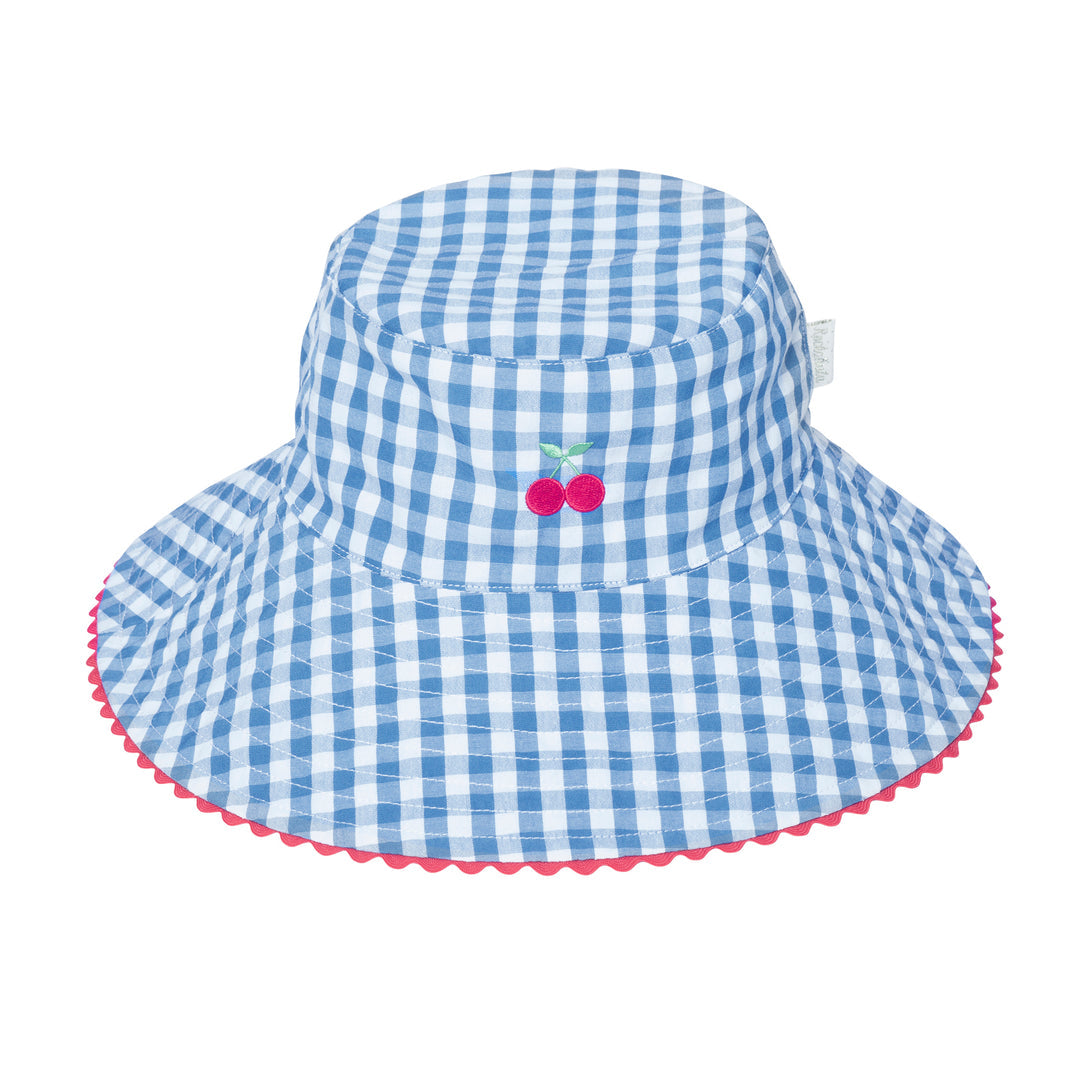 A reversible girls bucket hat by Rockahula, style Cherry Gingham,one side is blue and white stripe cherry print, the other blue and white gingham with cherry embroidery. Front view of gingham side of hat.