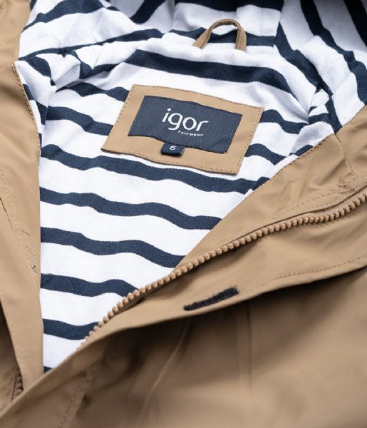 A unisex raincoat by Igor, style Euri Marino, in light brown elmwood with white and navy stripe lining and zip fastening. Close up of lining and label.