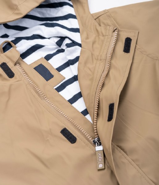 A unisex raincoat by Igor, style Euri Marino, in light brown elmwood with white and navy stripe lining and zip fastening. Close up of lining and fastening.