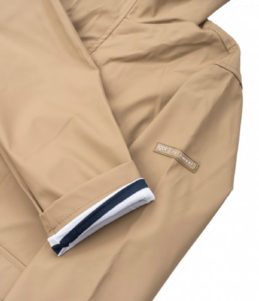 A unisex raincoat by Igor, style Euri Marino, in light brown elmwood with white and navy stripe lining and zip fastening. Close up of contrasting lining on sleeve.