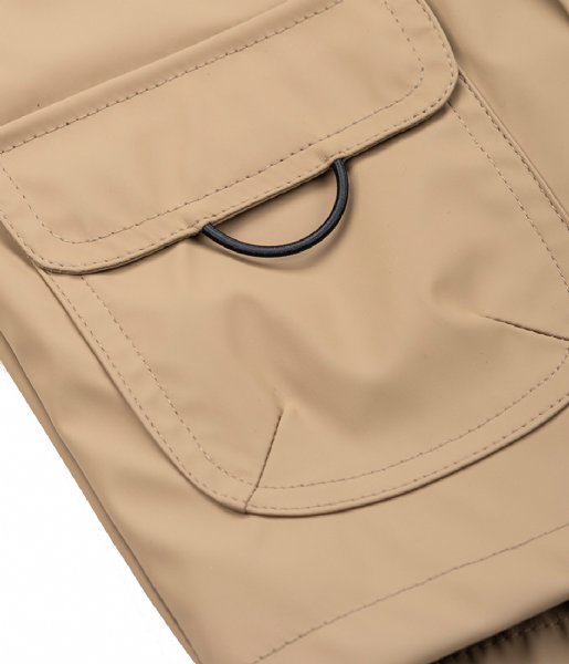 A unisex raincoat by Igor, style Euri Marino, in light brown elmwood with white and navy stripe lining and zip fastening. Close up of pocket.