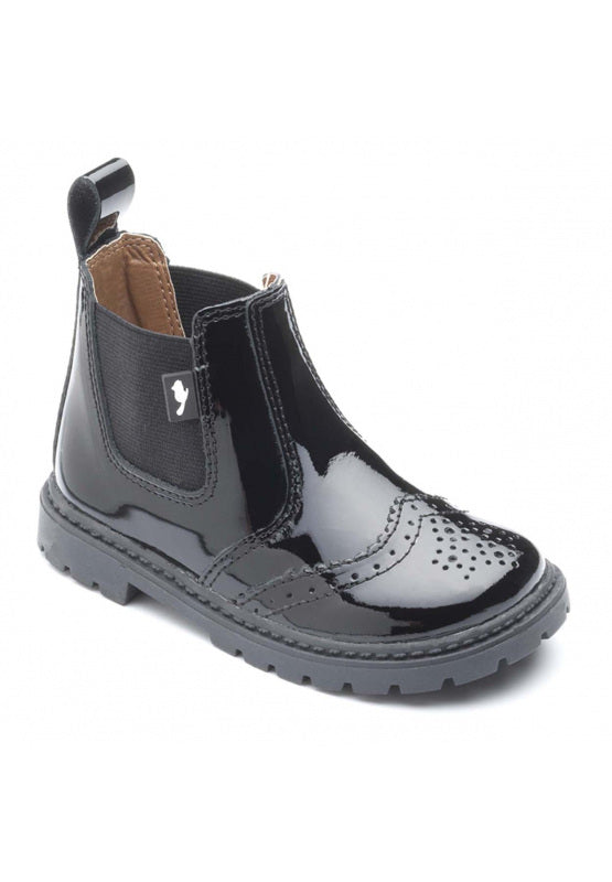 A girls pull on Chelsea boot by Chipmunks, style Riley, in black patent leather. Angled view.
