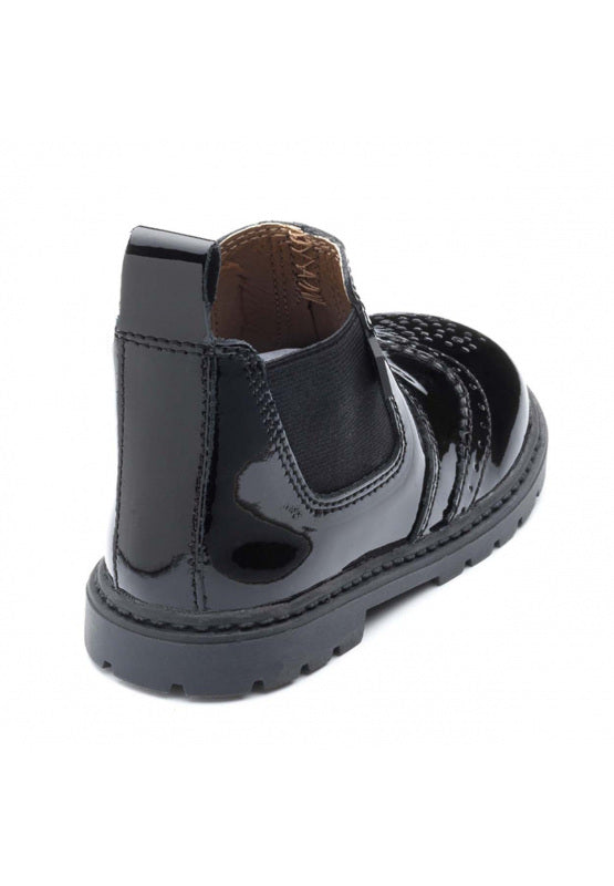 A girls pull on Chelsea boot by Chipmunks, style Riley, in black patent leather. Angled view.