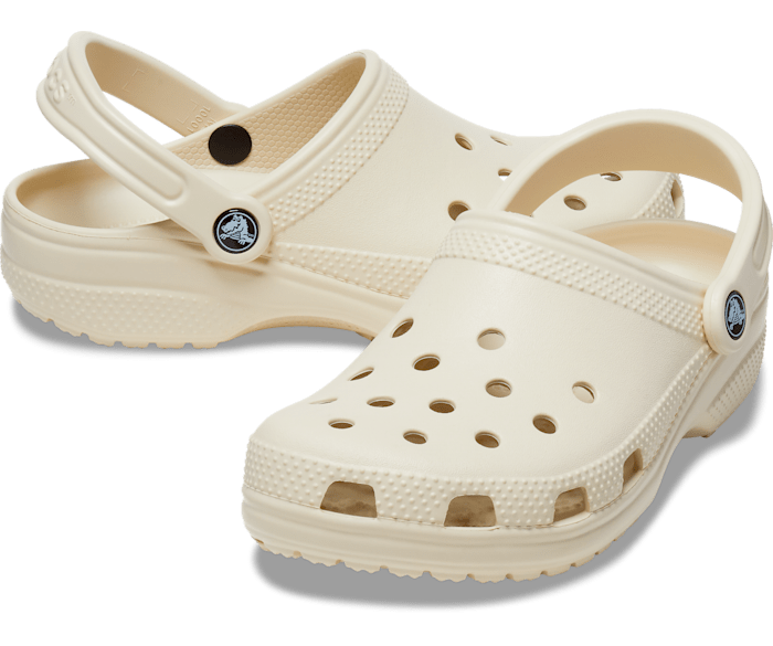 A unisex classic clog by Crocs, style Todd in bone. Angled left shoe, right side view.