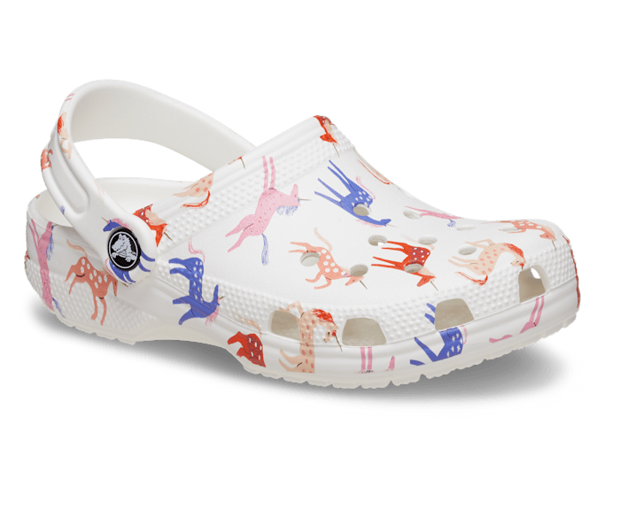 A classic clog by Crocs, style Tod in white with unicorn print. Right angled view.