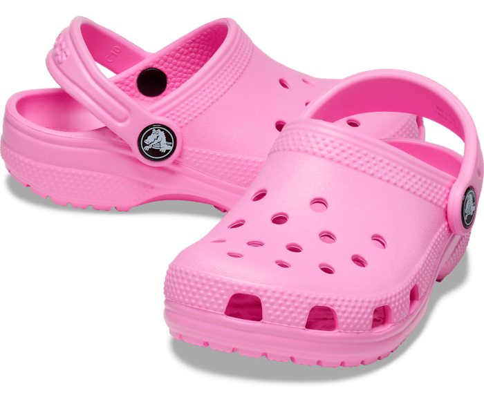 A girls classic clog by Crocs, style Todd in pink. Right side, left angled view.