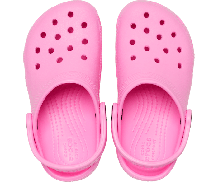 A girls classic clog clog by Crocs, style Todd in pink. Above view of a pair.