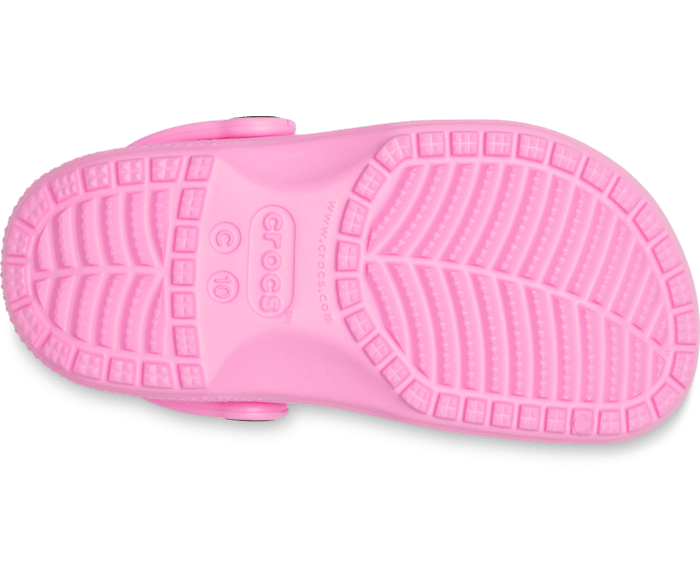 A girls classic clog by Crocs, style Todd in pink. Right sole view.