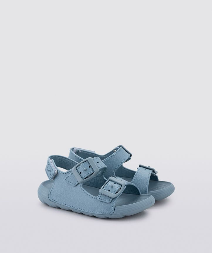 A boys sling back rubber shoe by Igor, style Maui in blue with two buckle straps and velcro heel fastening. Angled  view.