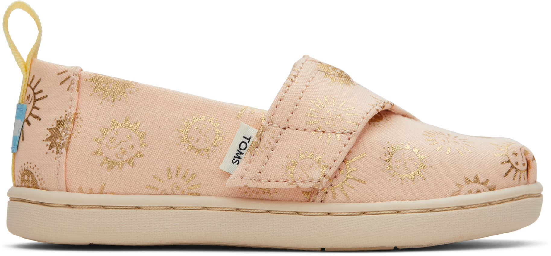 A girls canvas shoe by TOMS, style Alpargata Sunny Days, in apricot with gold foil detail and a velcro strap. Right side view.