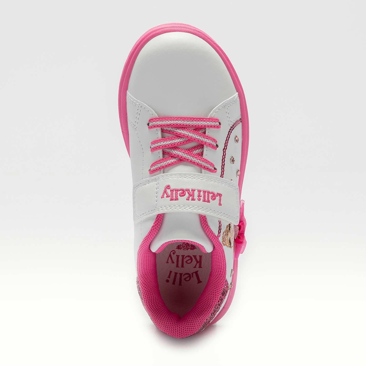 A girls casual trainer by Lelli Kelly, style Mille Stelle, in white and pink with velcro fastening. Above view.