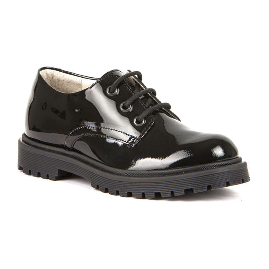 A girls school shoe by Froddo, style Lea L, in black patent with lace up fastening. Angled view.