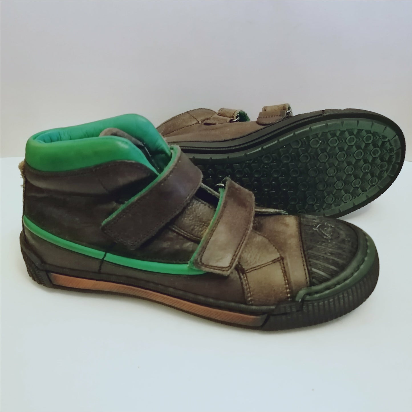 A boys boot by Rondinella, double velcro with rubber toe, in grey with green stripe and cuff. Right side view, left view of sole.