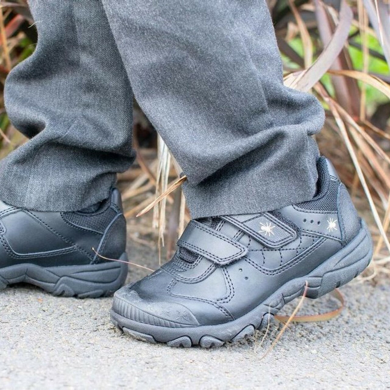 A pair of boys school shoes by Start Rite,style Tarantula, in black leather with double velcro fastening. Left side view.