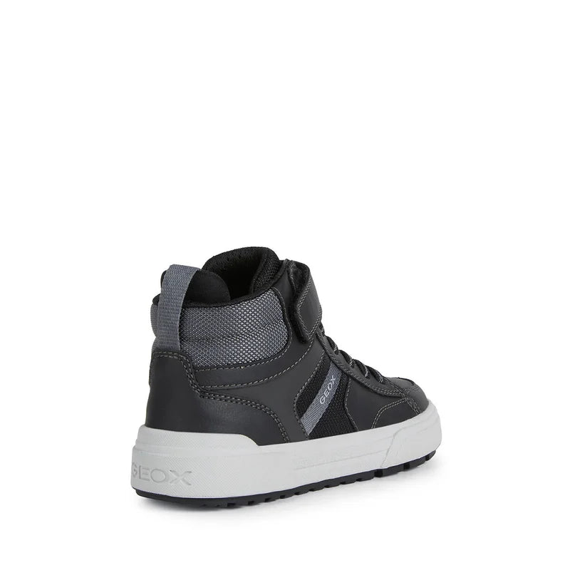 A boys Hi-top by Geox, style J Weemble Boy, in black and grey, velcro fastening with elastic laces. Back angled view.